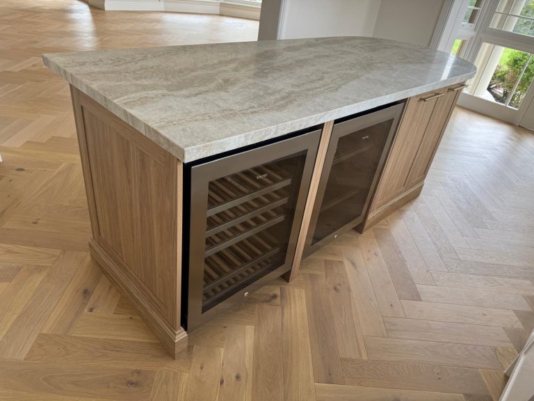 Timber kitchen island with stone benchtop and built-in wine fridges by Wondrous Kitchen & Bathroom.